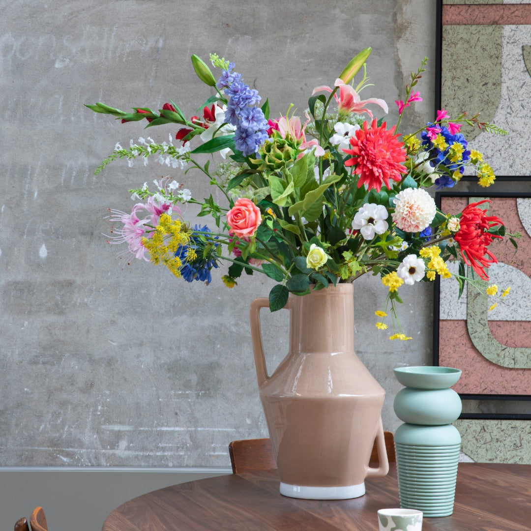 Kunstbloemen op tafel thuis in een leuke vaas
